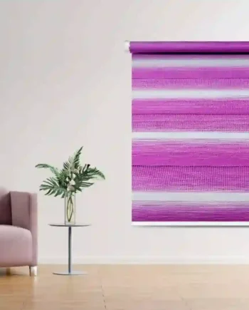 Vibrant pink Zebra Window Blind with bold horizontal stripes, installed in a chic living room featuring a blush armchair and a decorative side table with a vase of greenery.