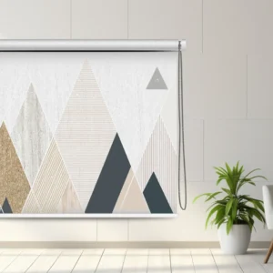 Modern geometric roller blind with triangular patterns in beige, gray, and white, displayed in a bright minimalist room.
