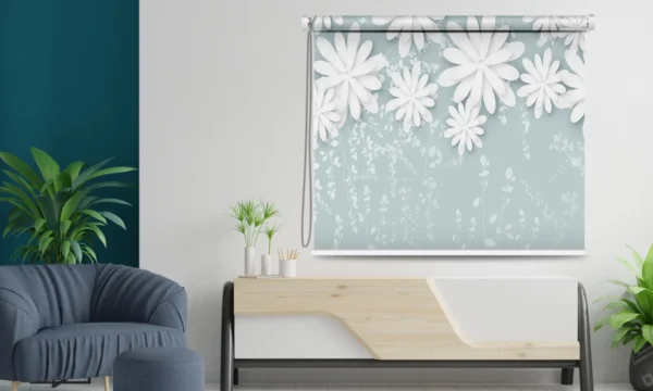 Floral roller blind with a soft blue background and white 3D-effect flowers, styled in a modern interior.