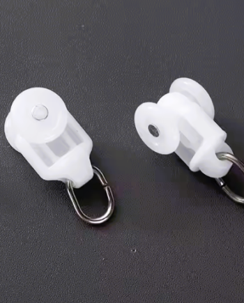 Set of white curtain M track runners with plastic wheels and metal hooks, displayed on a dark surface for detail clarity.