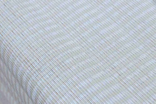Natural white jute blinds for windows with textured woven design, featuring a manual pull chain and automated mechanism, set against a dark brown background.