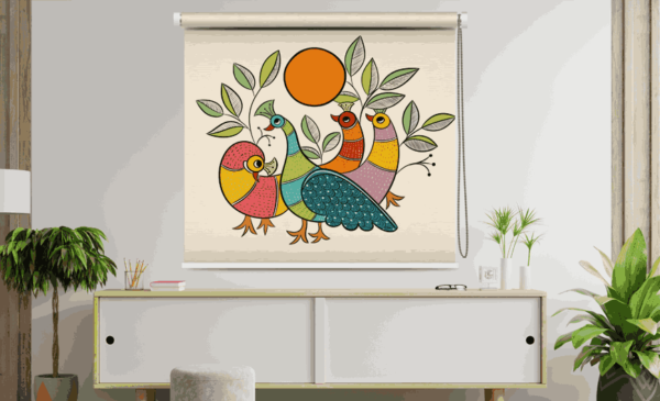 Colorful Bird and Peacock Roller Blind with traditional folk art design featuring four stylized birds under an orange sun, surrounded by leafy branches, mounted in a modern interior with plants and minimalist furniture.