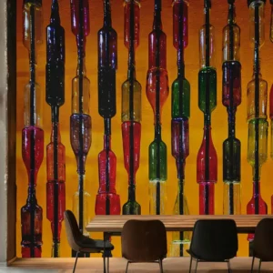 Colorful Wine glass bottle wallpaper mural on a glowing orange background in a modern dining or bar space